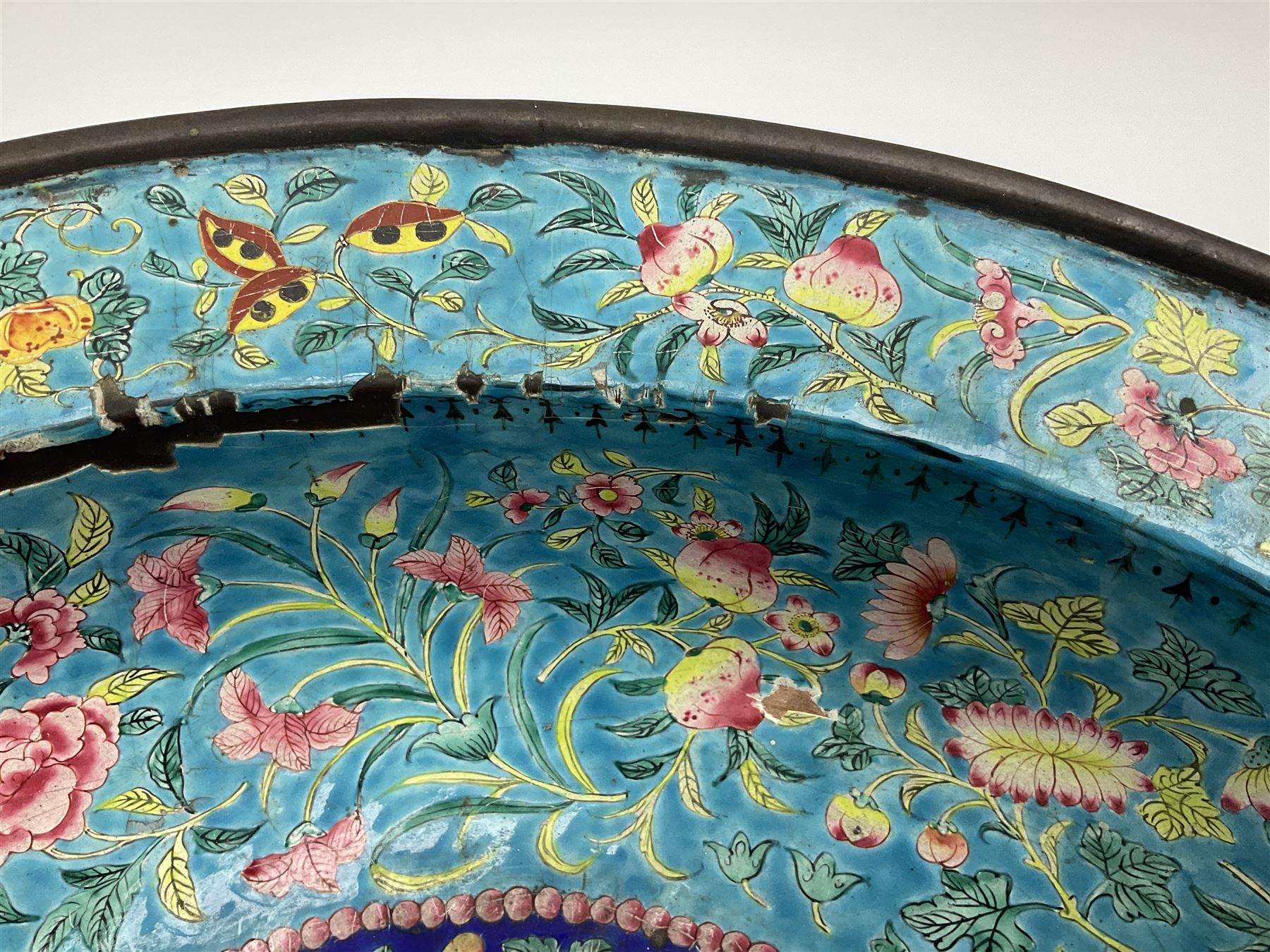 18th/19th century Chinese Canton enamel basin, the circular basin with flat everted rim, decorated with scrolling foliate and fruit decoration on a blue ground, D43cm