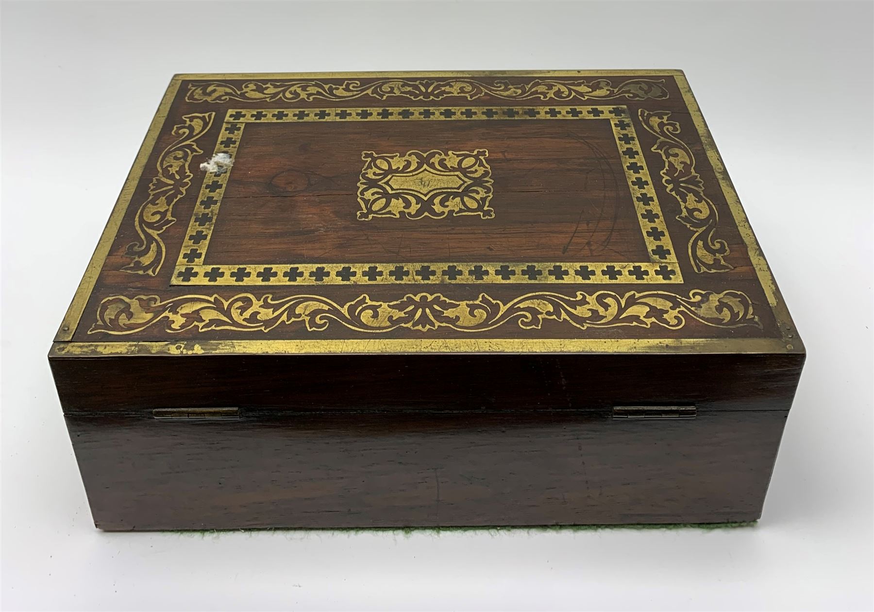 Victorian rosewood vanity box, with scrolling foliate brass inlay and twin brass inset campaign style handles, the hinged cover opening to reveal a gilt tooled interior with divisions, L33cm D22.5cm H13cm