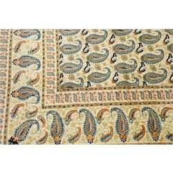 Central Persian Kashan hand-knotted carpet, ivory field densely decorated with all-over repeating botehs motifs, arranged in rows and enclosed by scrolling vine work and floral sprays, in a palette of indigo, pale blue, sage green and muted terracotta tones, within ivory borders of small boteh motifs flanked by border within large scale boteh motifs with multiple guard stripes, with cotton fringe ends 