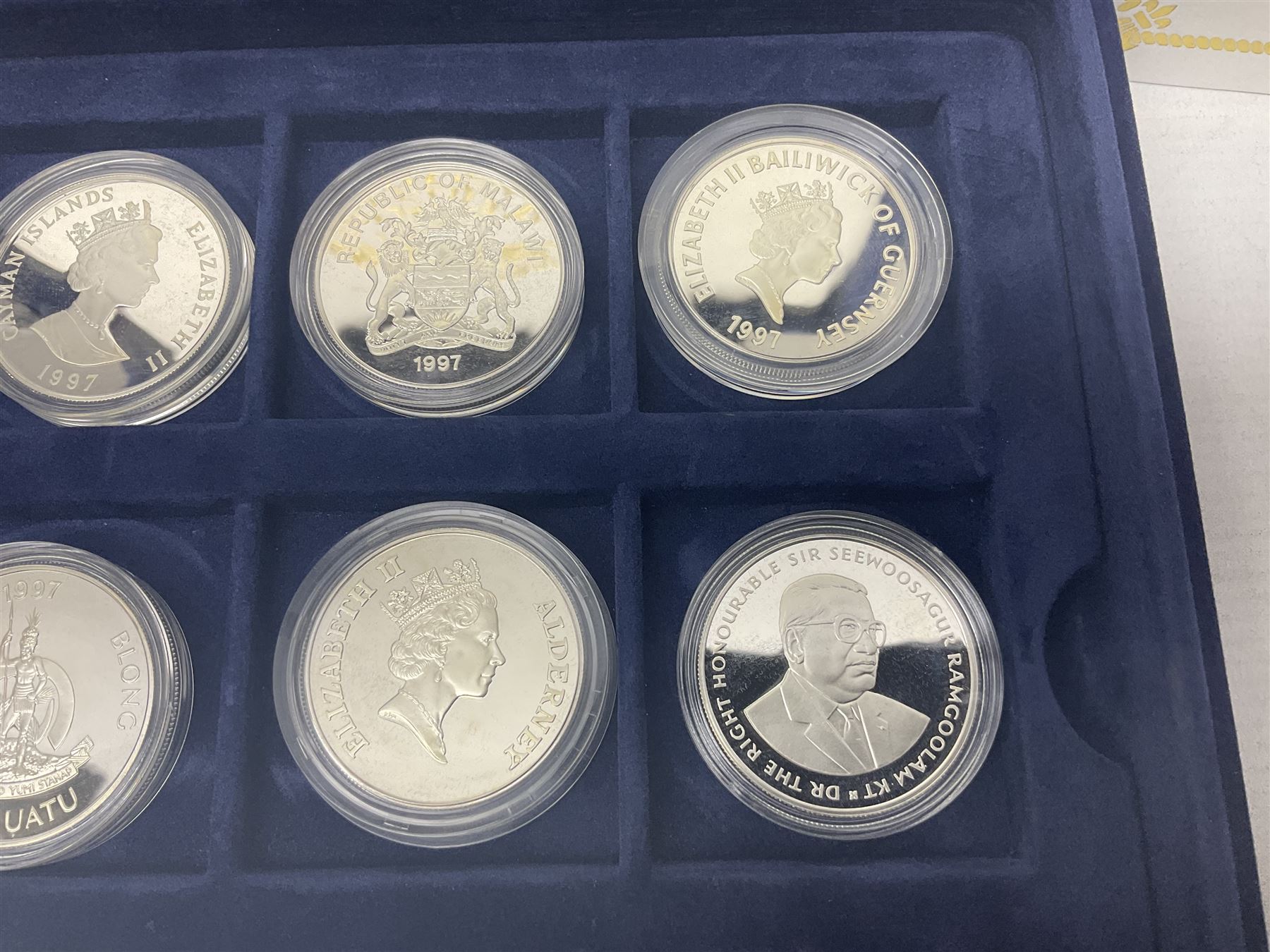 The Royal Mint Golden Wedding Anniversary silver proof coin collection, comprising twenty-four international commemorative coins, cased with certificates