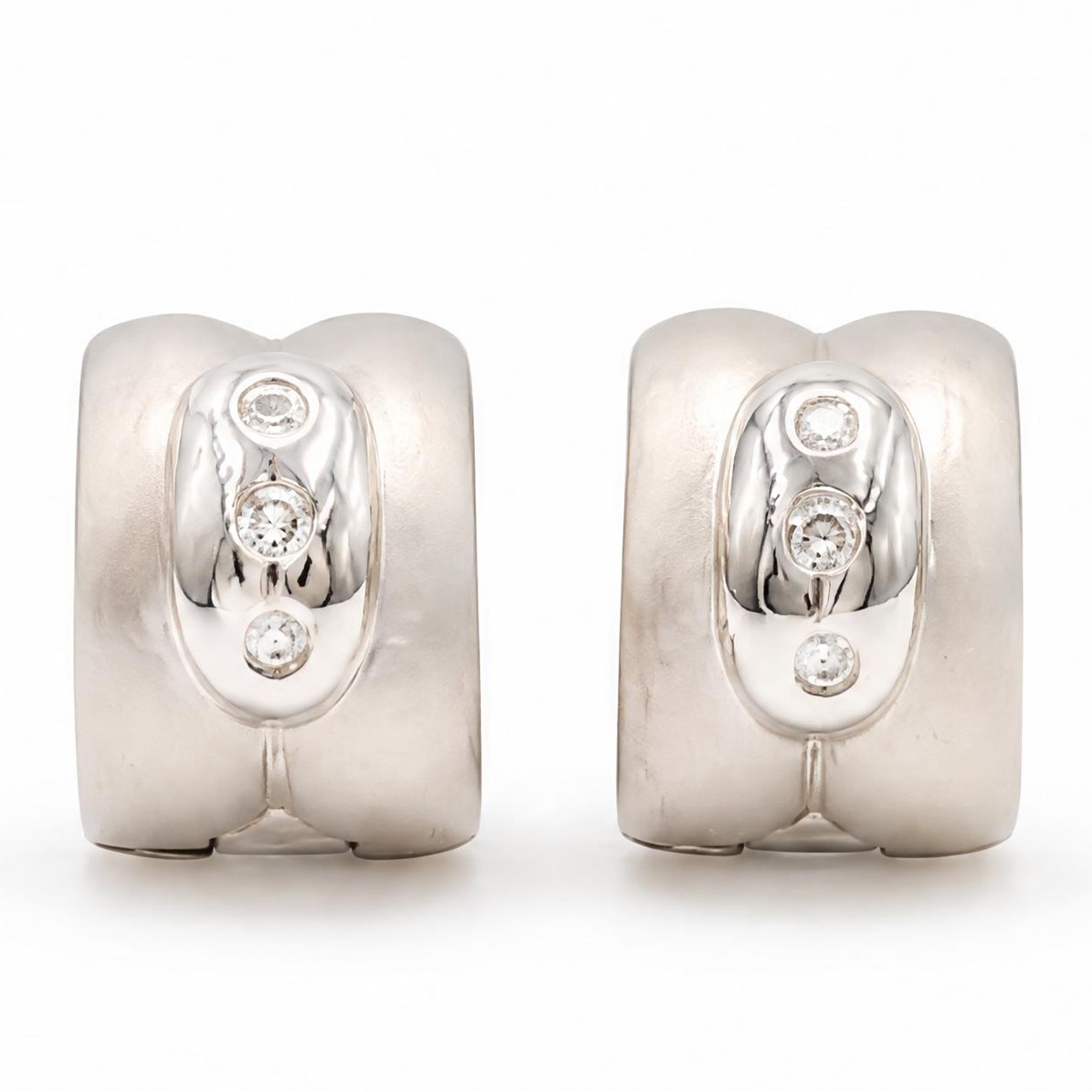 Pair of 18ct white gold diamond brushed and polished hoop earrings, each rubover set with three round brilliant cut diamonds, to a pierced design back, stamped 750