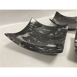 Set of four square dishes in two sizes, each with orthoceras and goniatite inclusions, age: Devonian period, location: Morocco, large dish D16cm