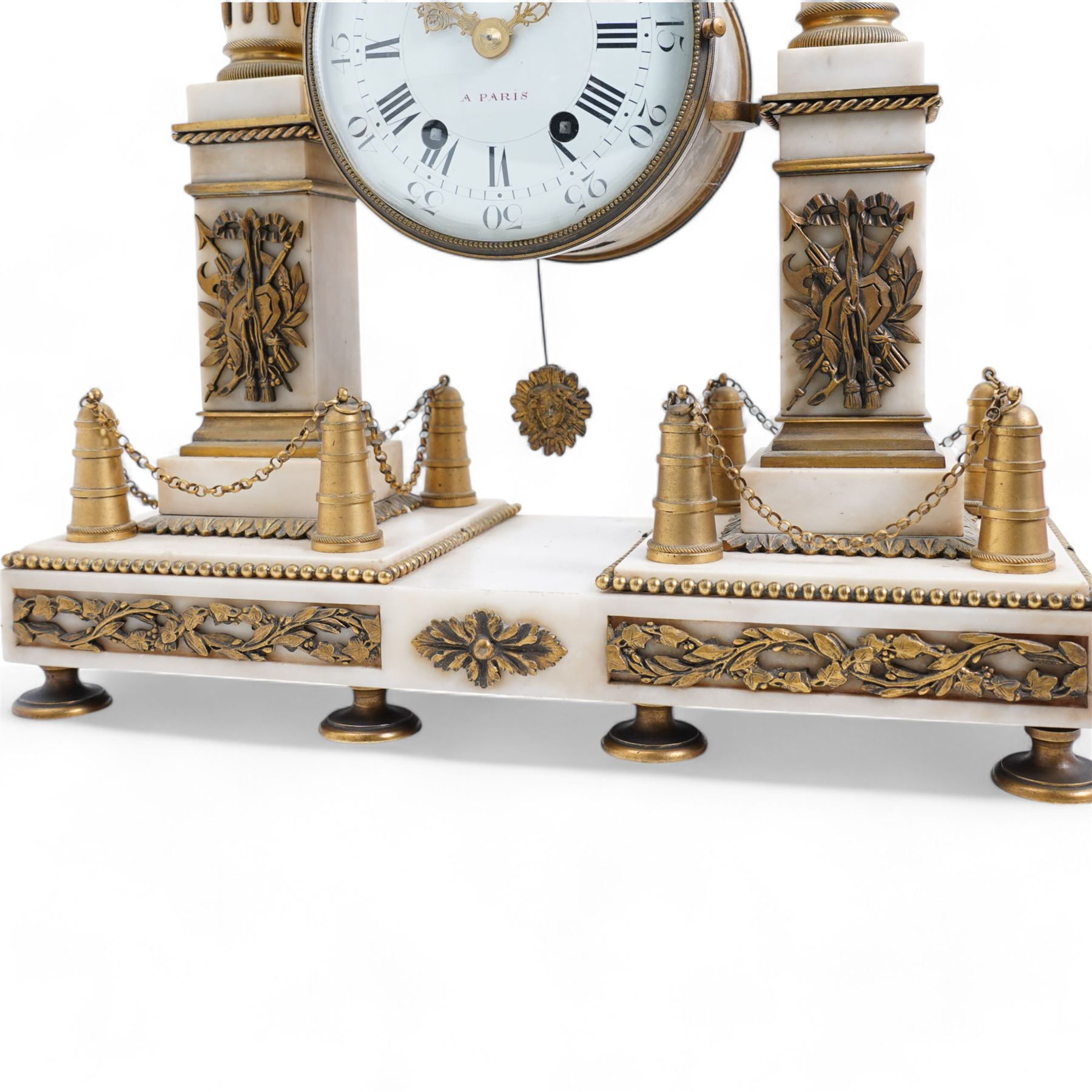 Chevallier of Paris - An early 19th century French Louis XV style white marble and gilt mounted portico clock surmounted by a figure from classical antiquity, with a drum case supported on a pair of reeded and tapered supports with celestial finials raised on a rectangular plinth base, with a white enamel dial with Roman numerals, five minute Arabic's, minute track and makers name,  8-day twin train countwheel movement with a silk suspension, striking the hours and half hours on a bell. 
With pendulum.