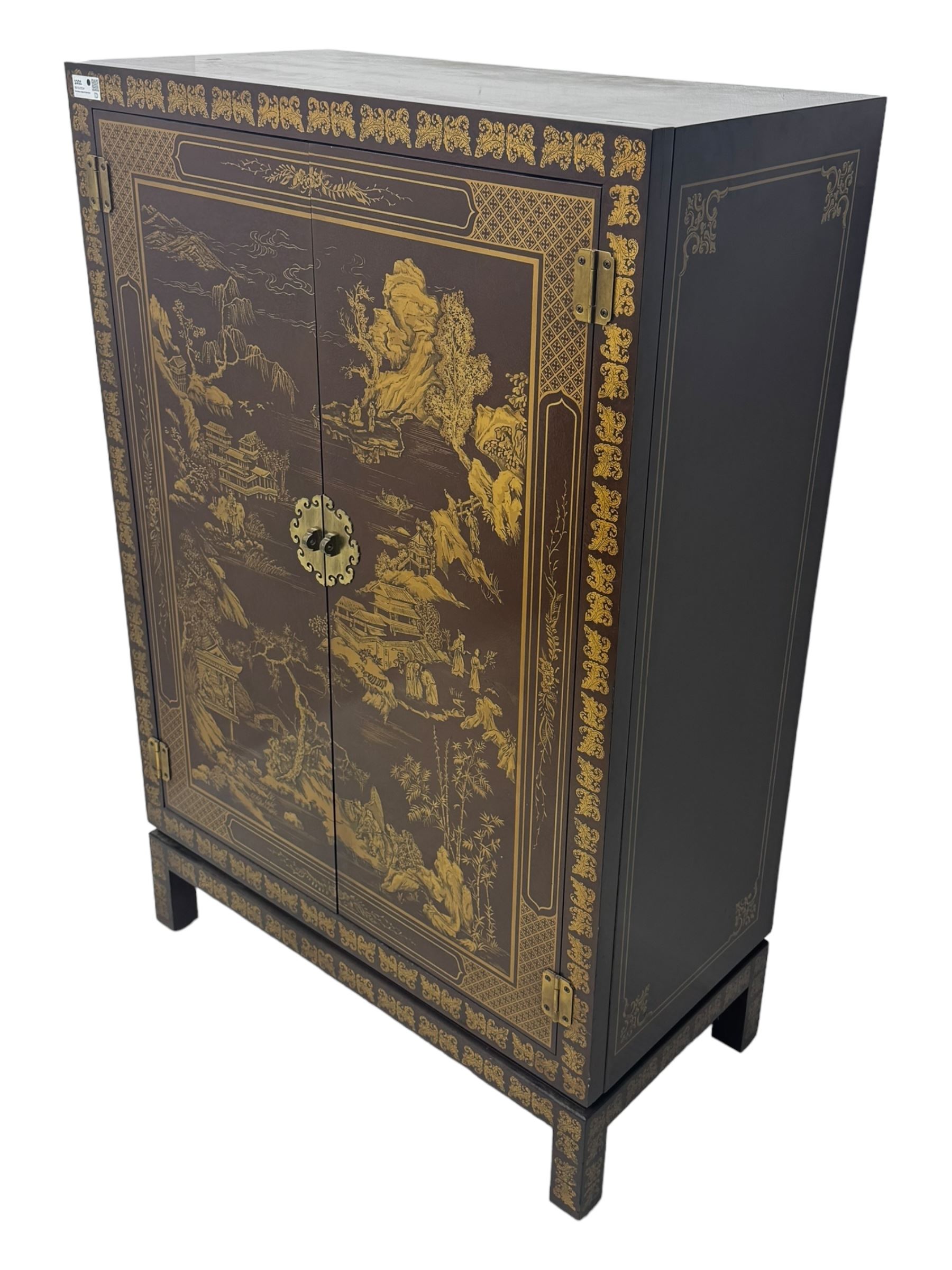 Chinese brown lacquered cocktail cabinet, decorated with gilt scenes of a traditional landscape with figures, pagodas, and mountainous scenery, double doors opening to reveal fitted interior with mirrored back, wine rack, shelves and cupboard, raised on square supports