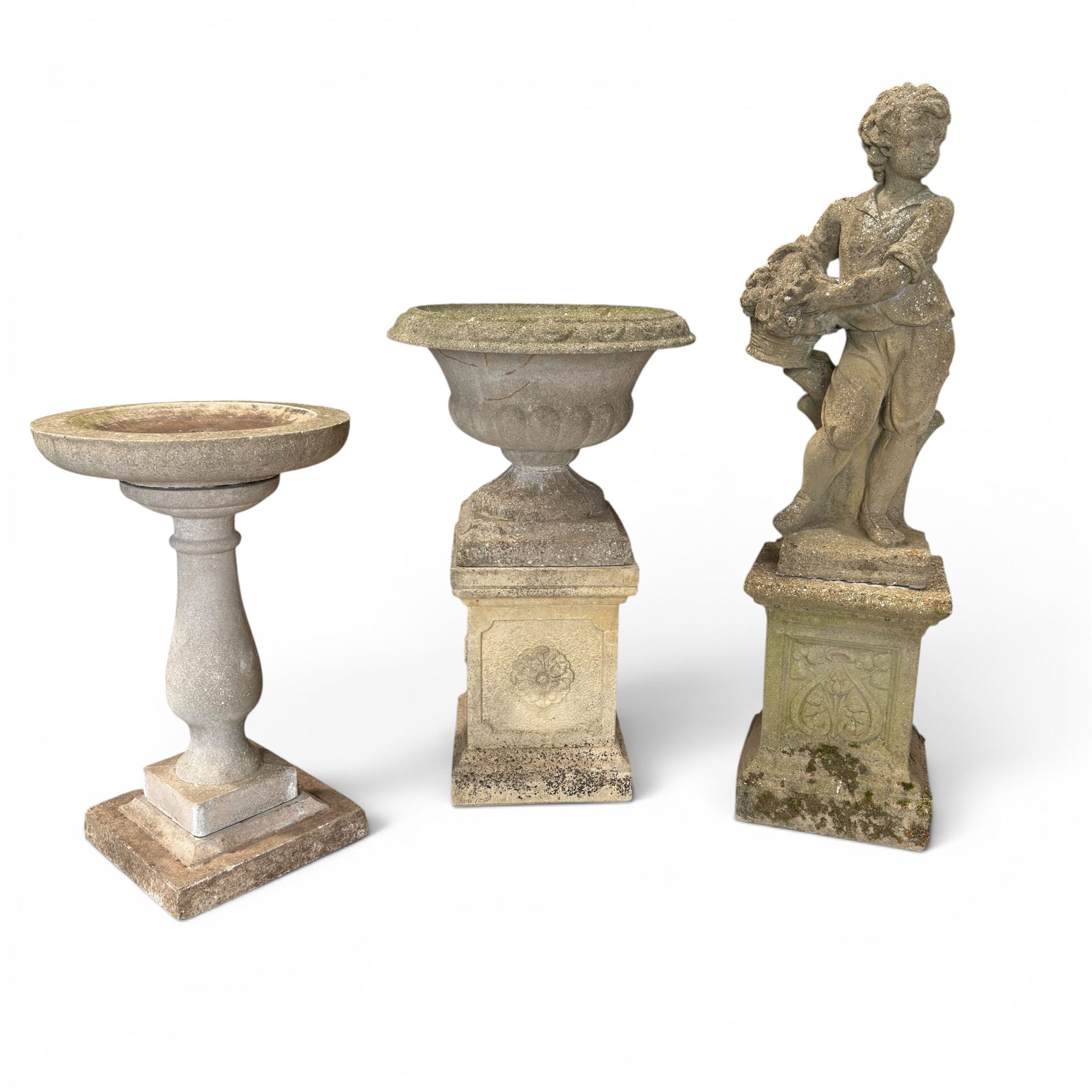 Weathered cast stone statue of a child and urn planter on pedestal along with three piece bird bath
