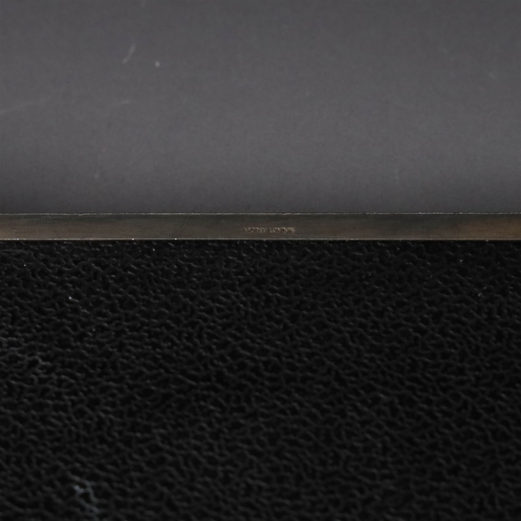 1960s silver mounted cigarette box, of rectangular form with engine turned decoration, upon four bracket feet, with presentation engraving to interior lid reading  'British Aircraft Corporation (Operating) Limited Commemorating the Queen's Award to Industry 1967, hallmarked James Geraghty, Birmingham 1965, with retailers mark for Asprey, W16.5cm, H4.5cm