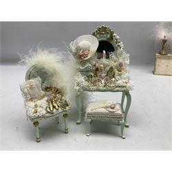 Collection of miniature dolls house ladies furniture and accessories, to include three piece green dressing table set decorated with lace and gilt, flowers, scent bottles, etc, upholstrered cream counter with makeup,  jewellery stand, gloves etc, ornate three tier shelving unit with various bottles, mannequins, hat boxes etc