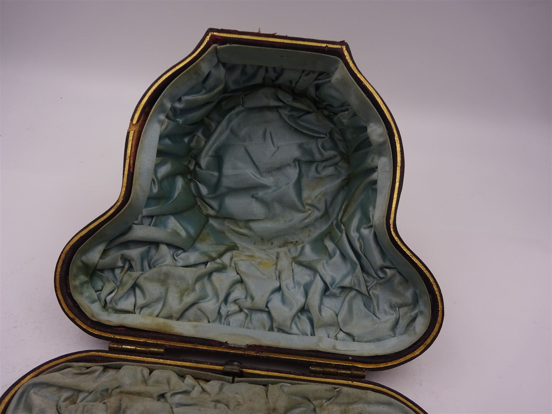 Victorian silver bowl, with embossed floral decoration and beaded rim, gilt interior and two applied shield cartouches, upon stepped circular foot, with a silver apostle spoon, with gilt bowl, both hallmarked George Unite, Birmingham 1883, bowl H5.5cm, within fitted tooled leather, silk lined case