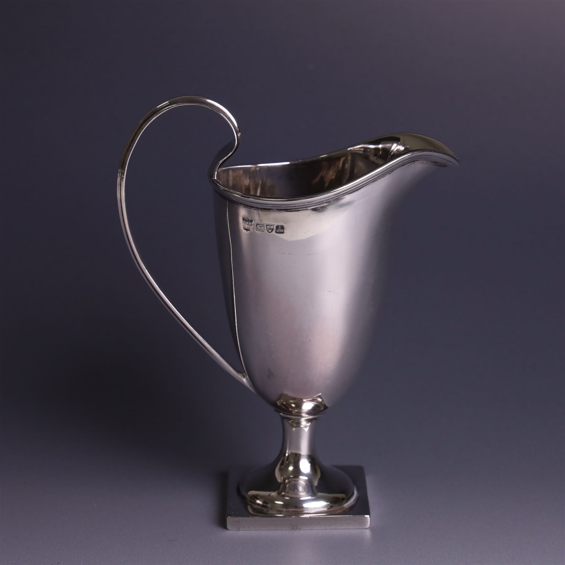 Edwardian silver helmet shaped cream jug, with plain bowl and upon a square base, hallmarked D & M Davis , Chester 1901, H13cm