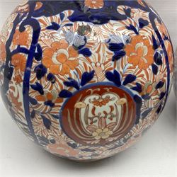 Pair of large 19th century Japanese Imari porcelain bottle vases, painted with shaped reserves of peonies, chrysanthemums and prunus blossom, each H46cm
