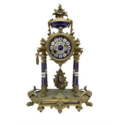French - late 19th century 8-day spelter portico clock, drum movement raised on four porcelain columns and surmounted by an oval urn, with a conforming dial, cartouche Roman numerals and brass spade hands, twin train Marti countwheel striking movement, striking the hours on a bell. with key. 