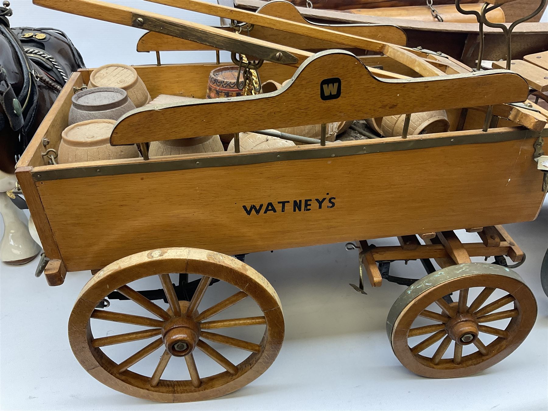 Four Melba Ware Shire horse figures and another similar, and three wood carts
