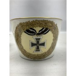 WW2 Nymphenburg cups and saucer, decorated with Imperial German Iron Cross encircled in a foliate boarder with gilt edging, with printed mark beneath 