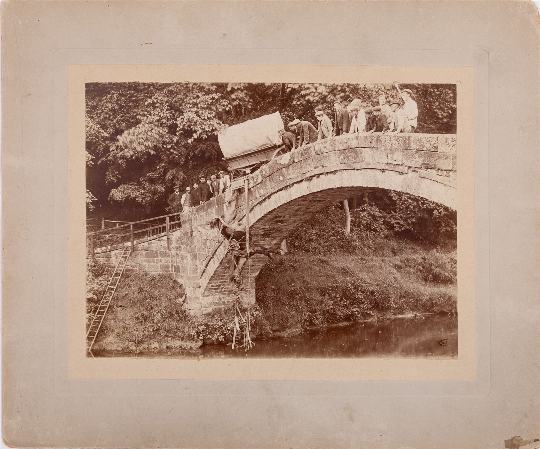 Photograph of An Incident at Beggar's Bridge - Glaisdale, showing a Horse being hauled back onto the bridge, further information verso, 15cm x 21cm (unframed)