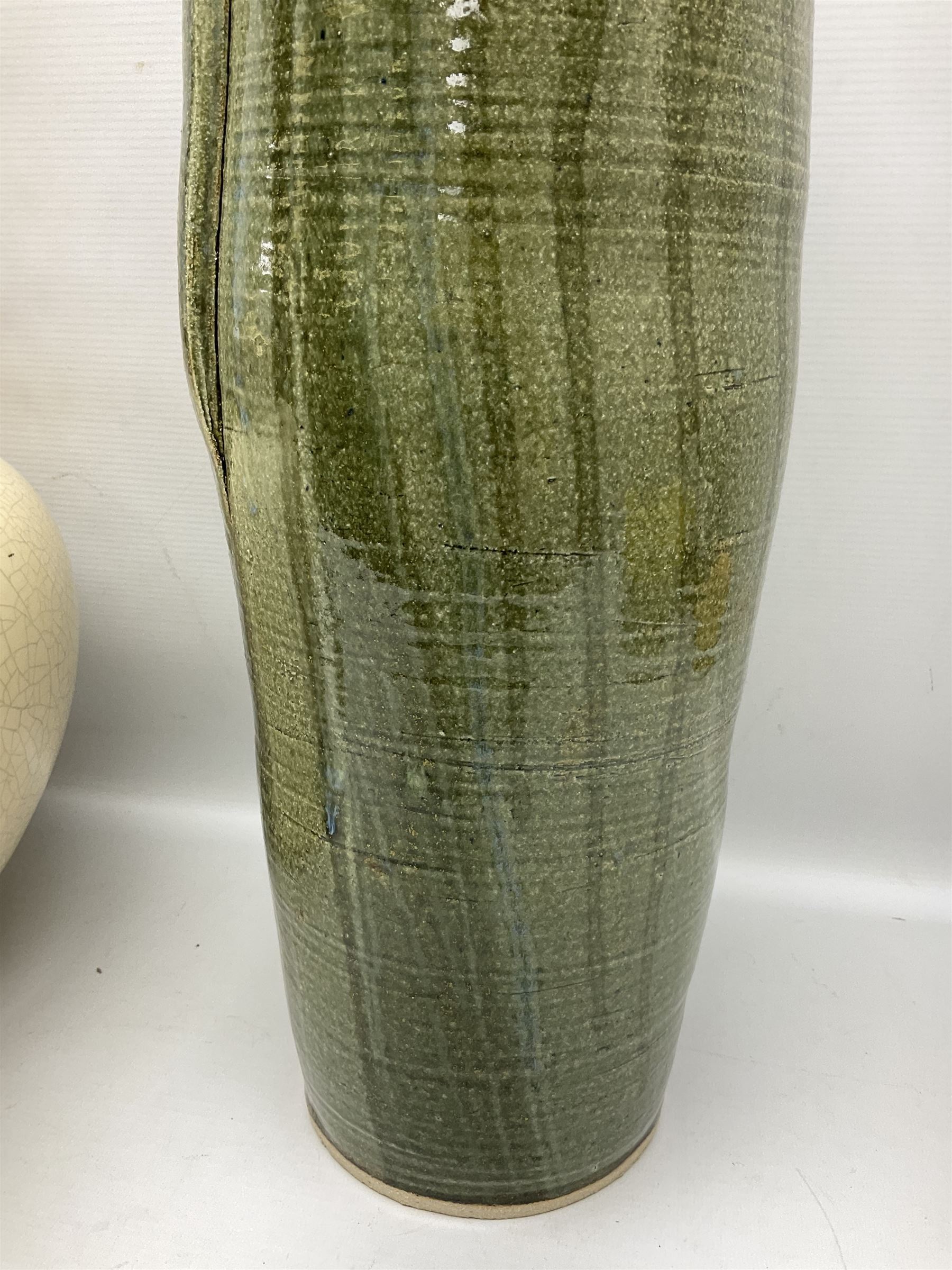 Large cream crackle glaze table lamp, together with a tall studio pottery vase in green with single loop handle, with impressed makers mark, H49cm