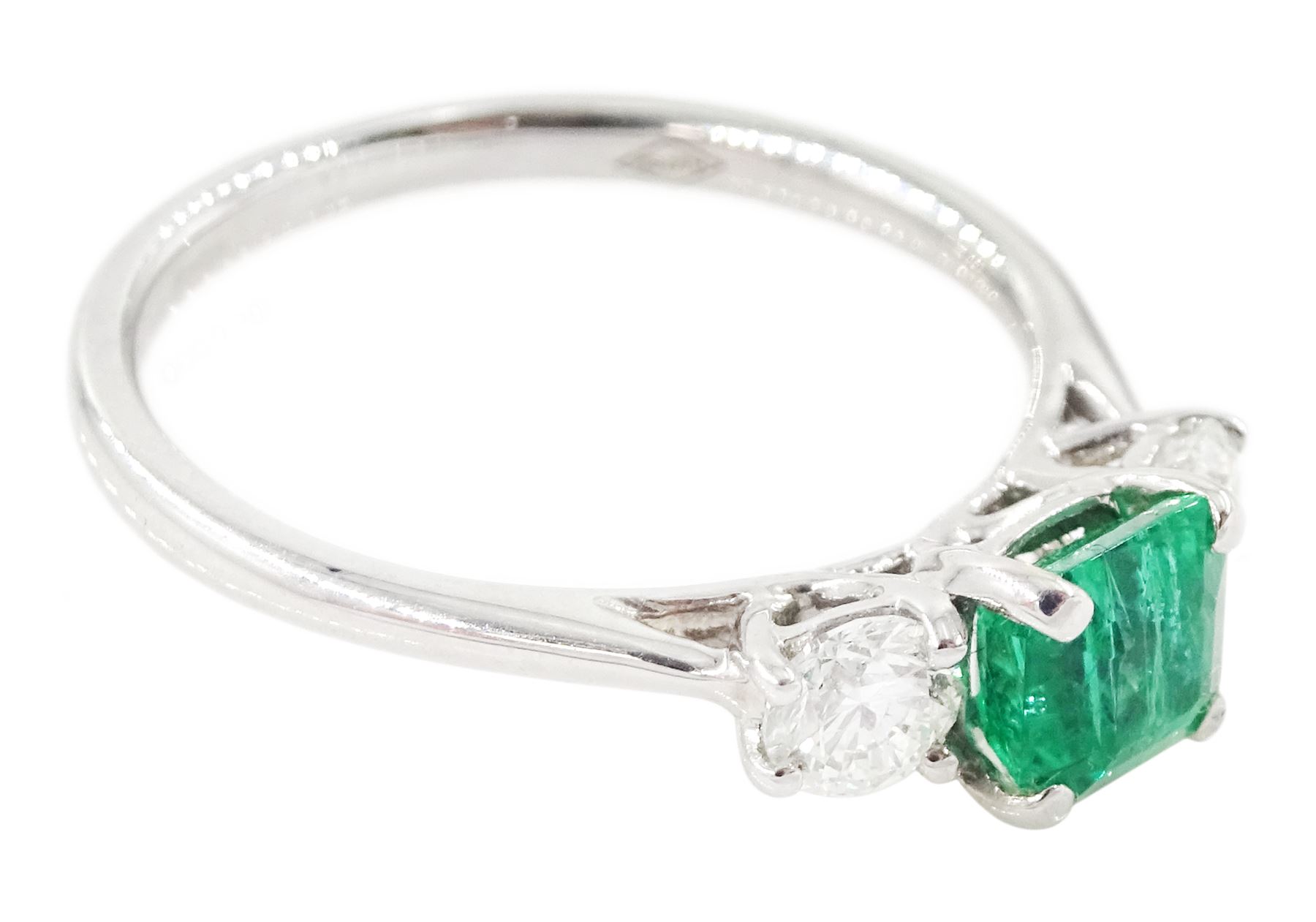 18ct white gold emerald and diamond three stone ring, single modified square cut emerald of approx 0.65 carat, with a round brilliant cut diamond set either side, hallmarked, total diamond weight approx 0.35 carat