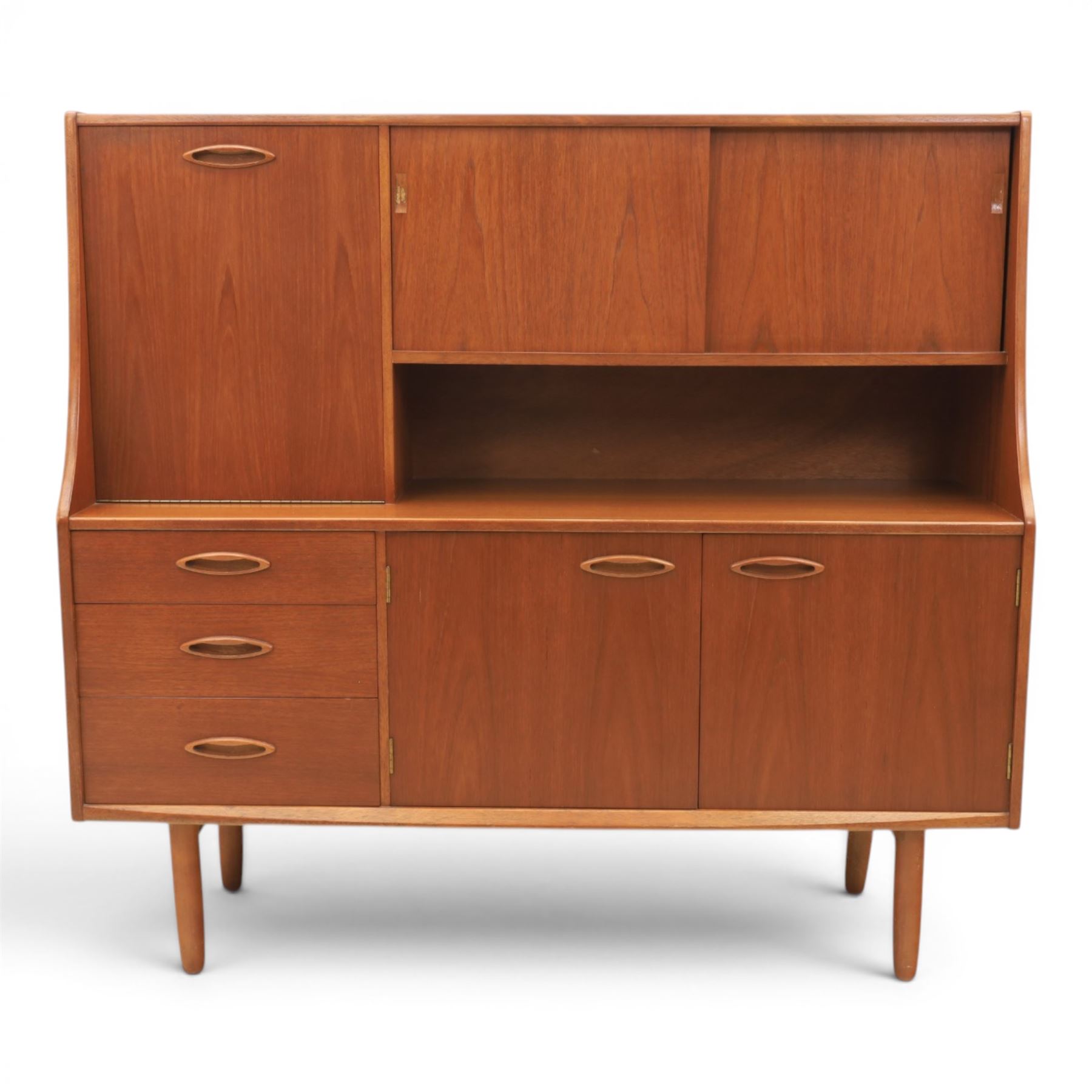 Jentique - mid-20th century teak highboard, fall front cabinet next to a sliding door cupboard above and open recess, the lower section with cabinet doors and three graduated drawers, raised on cylindrical legs