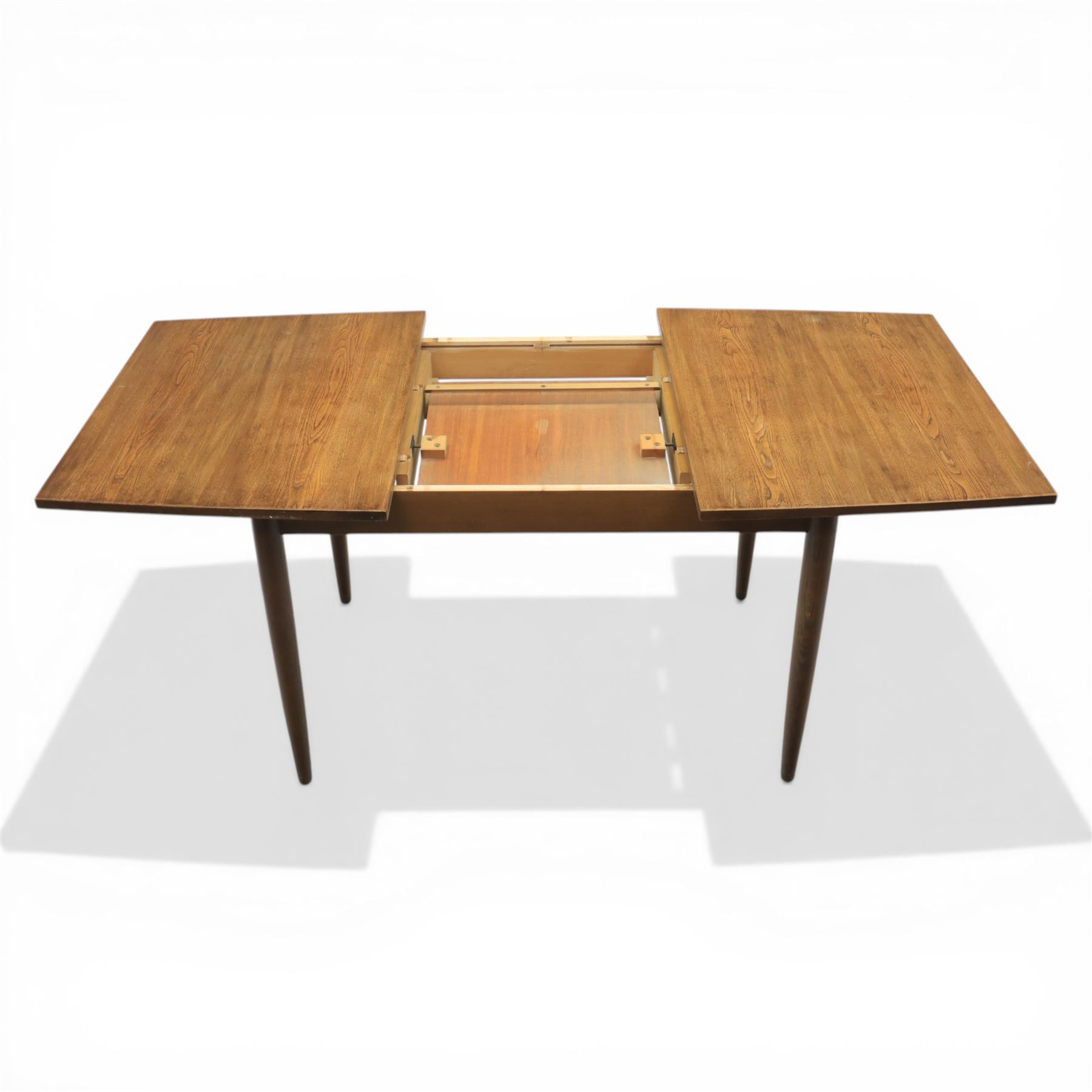 Ensign - Mid-20th century elm extending dining table, with fold out leaf, bow ends and sides; and four low stick back chairs, labelled Ensign Bristow & Townsend Ltd, extended 168cm