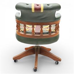 Late 20th century captain’s swivel desk chair, button upholstered back and seat in green leather with Union Jack motif panels, brass stud edging, curved padded arms with turned spindle supports, revolving and height adjustable action, on a five branch wooden base with castors