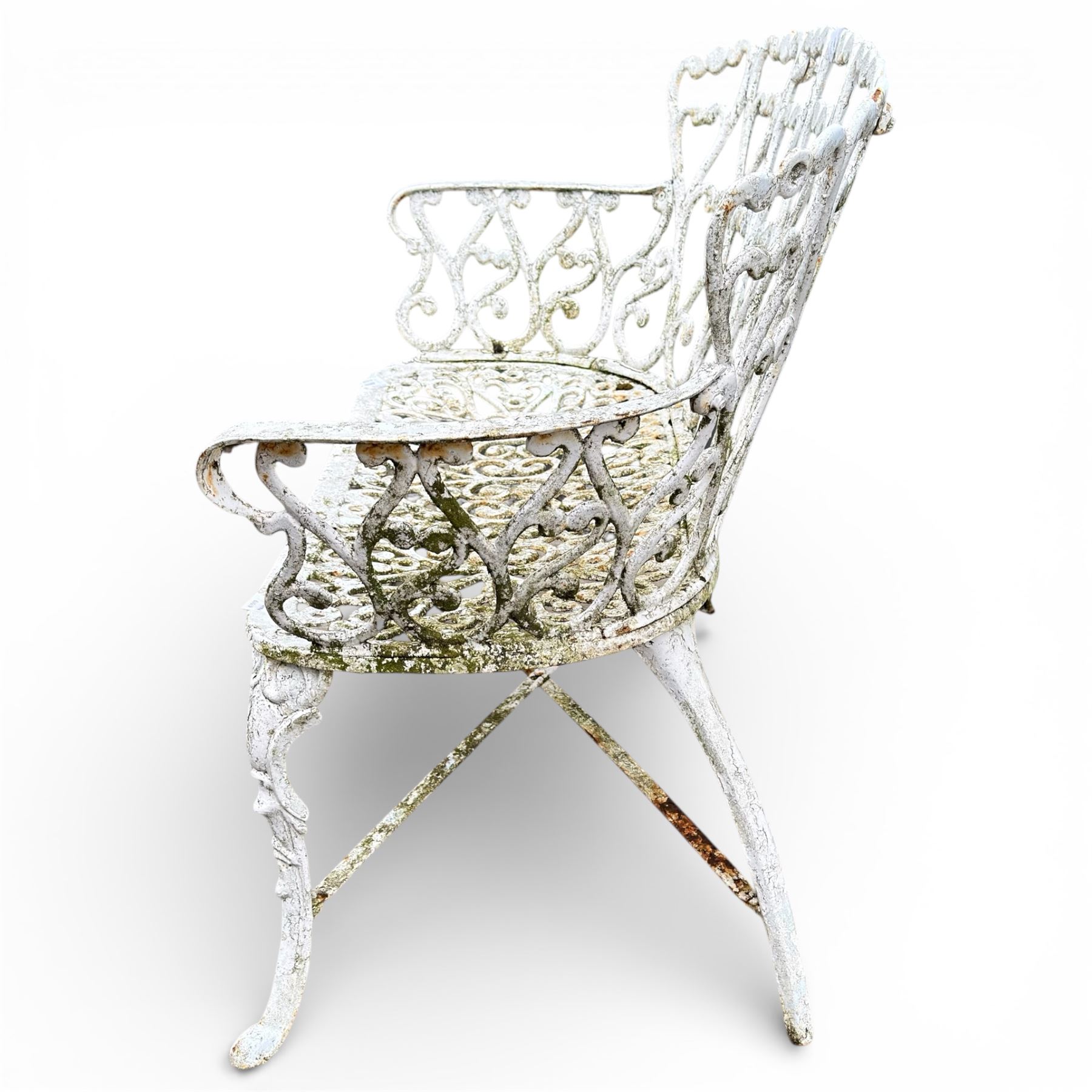 White cast metal garden bench in an antique style