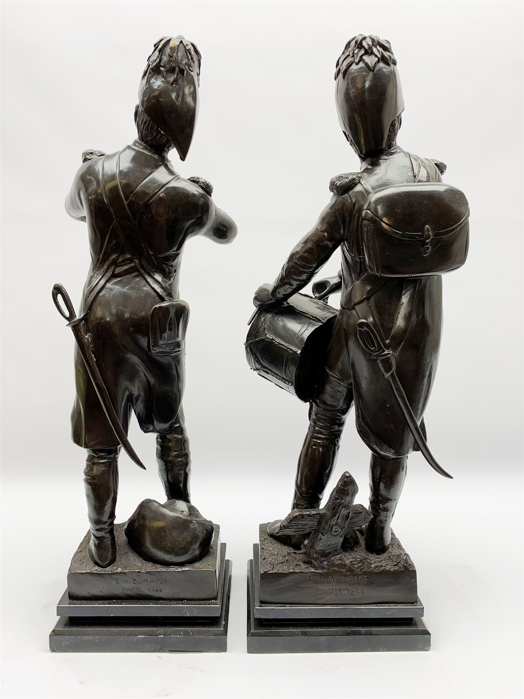 After Etienne-Henri Dumaige (1830-1888): 'Avant de Combat Volontaire de 1792' and 'Apres de Combat Grenaider de 1792', pair of large bronze figures modelled as French Revolutionary soldiers, each upon rectangular stepped black marble base, signed E H Dumaige, Paris 1888, tallest example H68.5cm