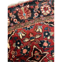 Persian Hamadan rug, red ground, the field decorated with central medallion and stylised flower motifs, repeating border 