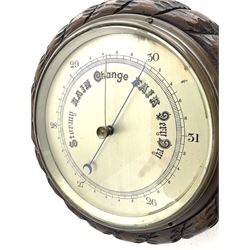 Mid 20th century circular oak cased barometer, silvered dial with register, rope carved edge moulding