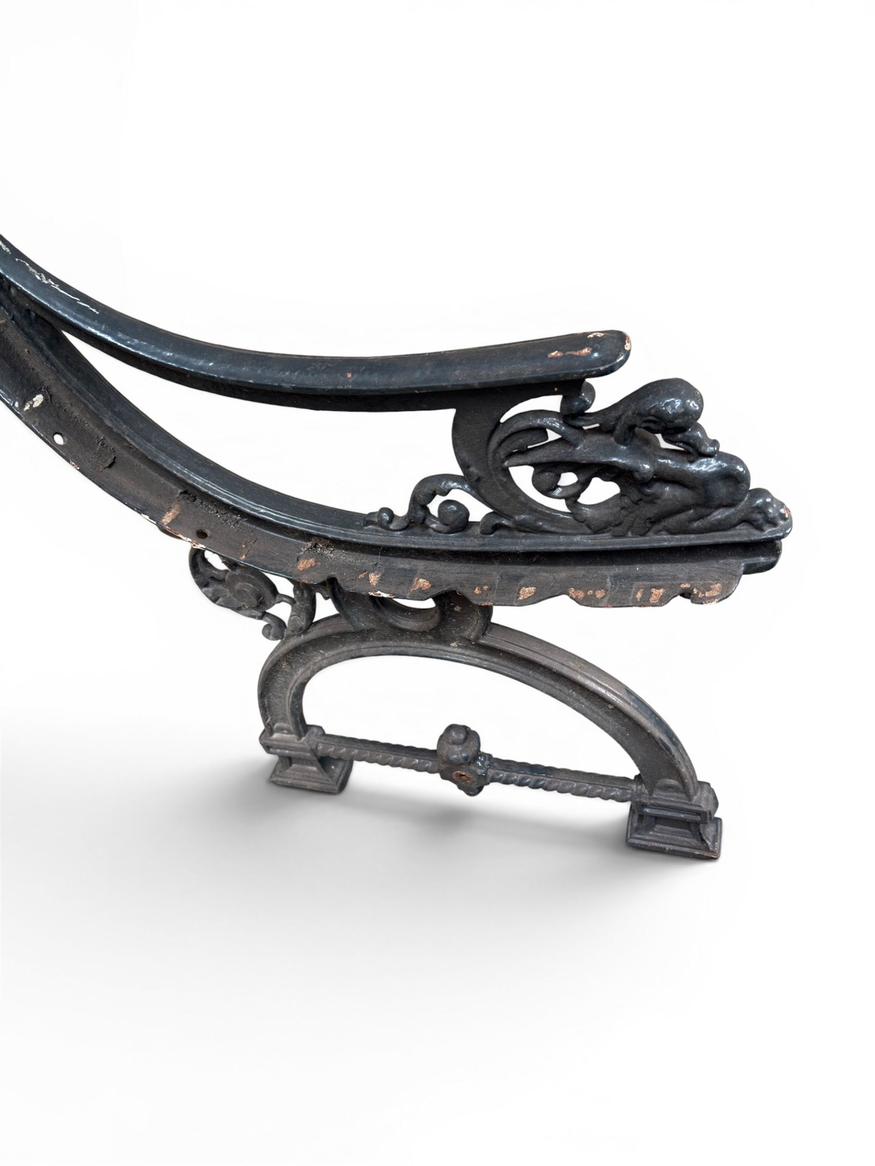 Yates Haywood - pair of 19th century cast iron bench ends, winged griffin detail, arched legs with rope turned decoration, finish in green paint, registration number 206550, first registered 8 March 1867 (see illustration), length as required