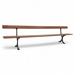 Pine garden bench, with stained and weatherproof varnish, single slat pine seat and back, raised on curved black cast iron supports