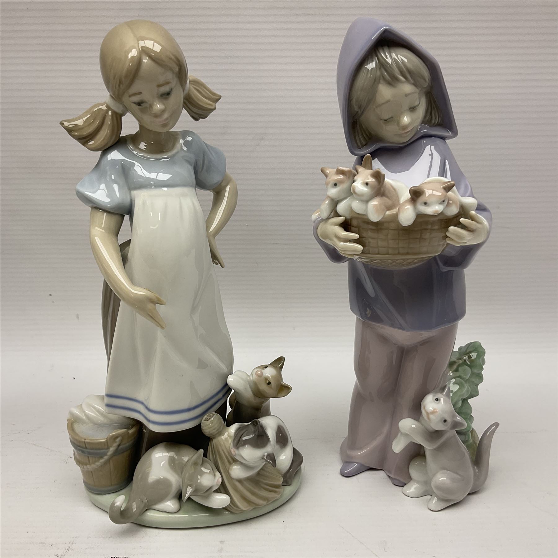 Five Lladro figures, including The Lamp Lighter no 5205,  Girl and Kittens no 6102, Cat no 5113 etc
