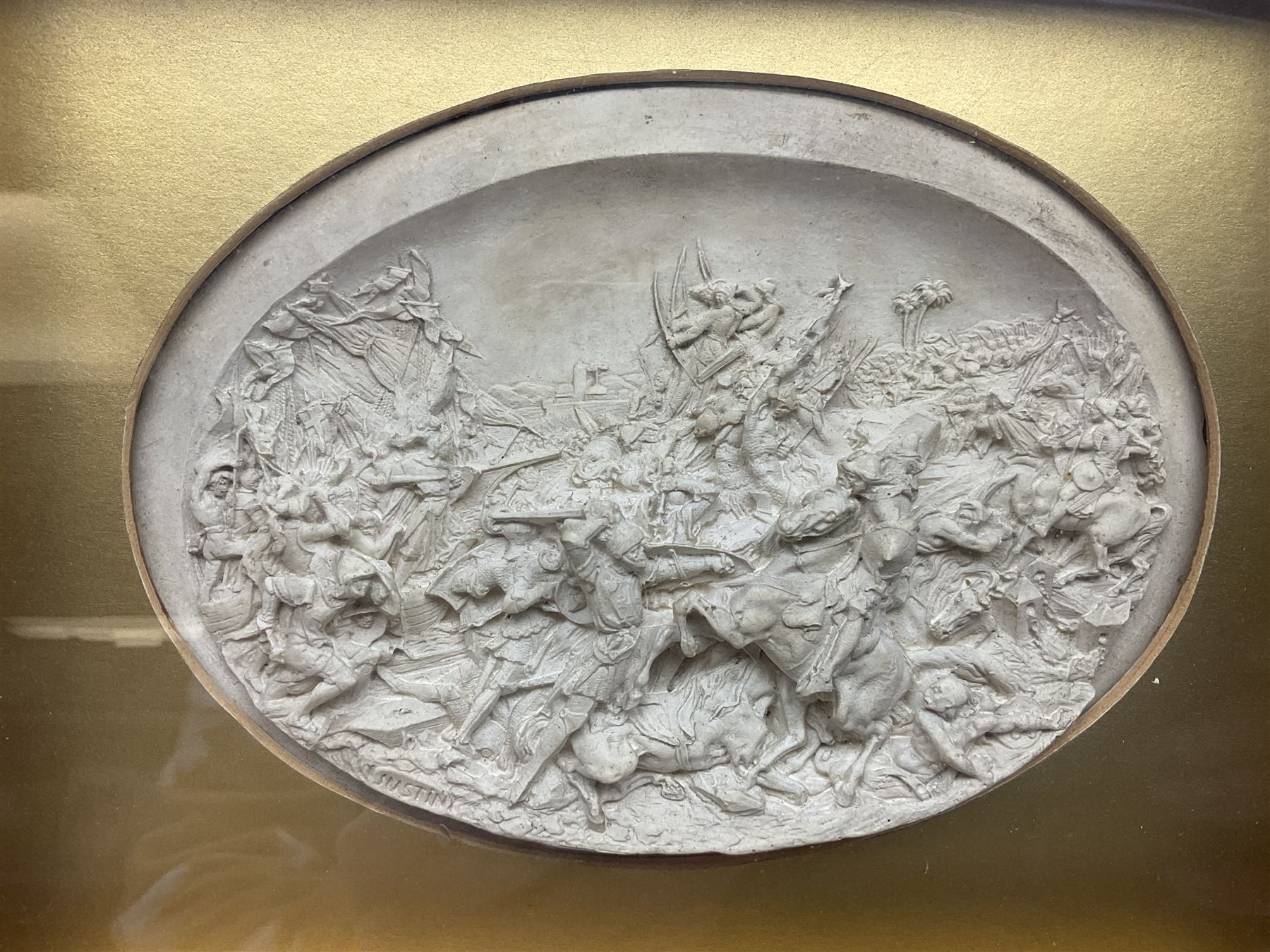 Justin Mathieu, two oval high relief plaque depicting a battle scenes, each within a wooden frame, frame  H21cm, L25cm