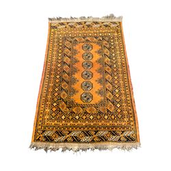 Small Bokhara rust ground rug, the field decorated with Gul motifs, multi-band border