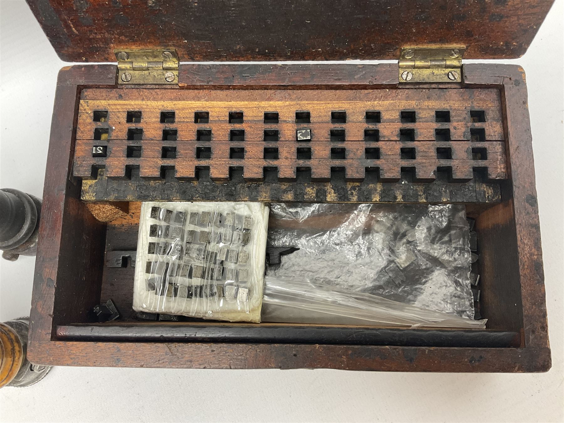 Two Post Office hand stamps 'Heversham Milnthorpe Cumbria' and 'Cimla Neath', together with two hand stamp bodies and various date numbers, housed in a fitted box