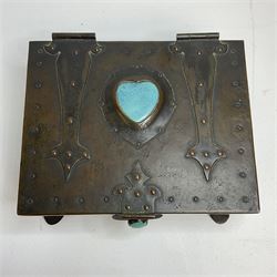 Arts and Crafts copper box, the lid decorated with stylised riveted hinges and inset with Ruskin type ceramic turquoise heart-shaped cabochon, the mount etched M.B 1913, and further cabochon roundel to each side panel, including one inset to the clasp acting as the knob to the locking mechanism, marked RS Douglas 1913 beneath, W16.5cm H7cm D15cm