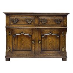Early 20th century Jacobean design oak dresser sideboard, rectangular top with moulded edge over two baize-lined drawers with pierced handles, above two fielded panel cupboard doors, on stile supports