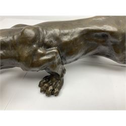 Bronze figure, modelled as a cougar in crouching pose, after Milo and with foundry mark, L40cm