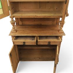 Late 19th century French pine dresser with stained glass upper section, the upper section with projecting cornice with fluted and scrolled details, enclosing a shelved interior, supported on turned front uprights, the lower section with frieze drawers and cupboard doors, raised on bun feet