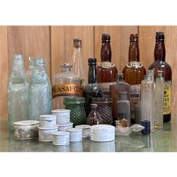 Collection of antique glass bottles and jars, including an apothecary bottle with gilt pap...