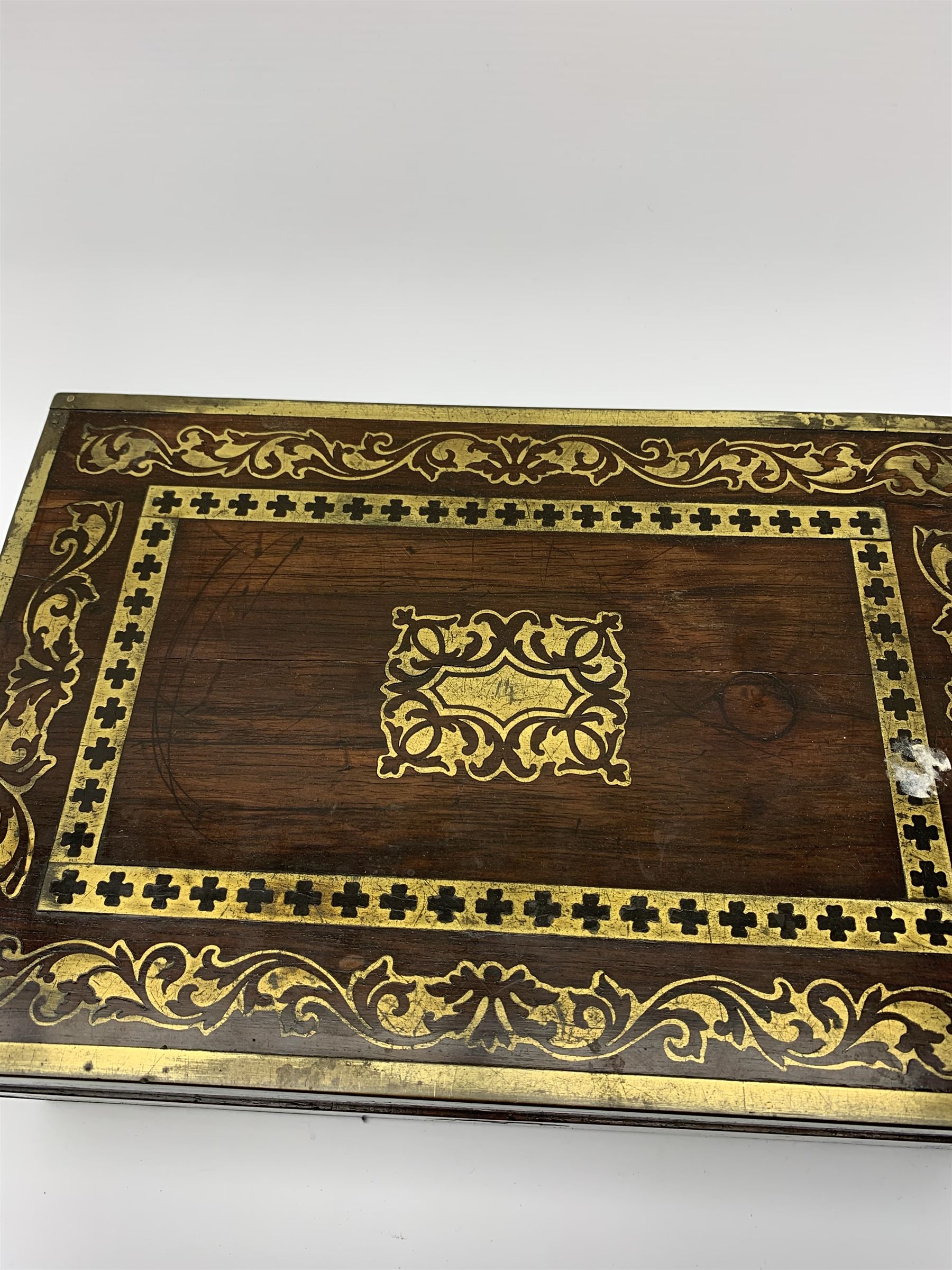 Victorian rosewood vanity box, with scrolling foliate brass inlay and twin brass inset campaign style handles, the hinged cover opening to reveal a gilt tooled interior with divisions, L33cm D22.5cm H13cm