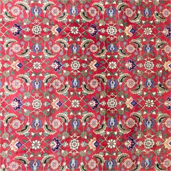 North West Persian Tabriz hand-knotted carpet, herati-type field in deep red with an all-over field densely decorated with scrolling floral sprays and palmettes on a lattice ground enclosed by a dark blue main border filled with stylized floral motifs and interlacing tendrils flanked by multiple guard stripes, with cotton fringe ends 