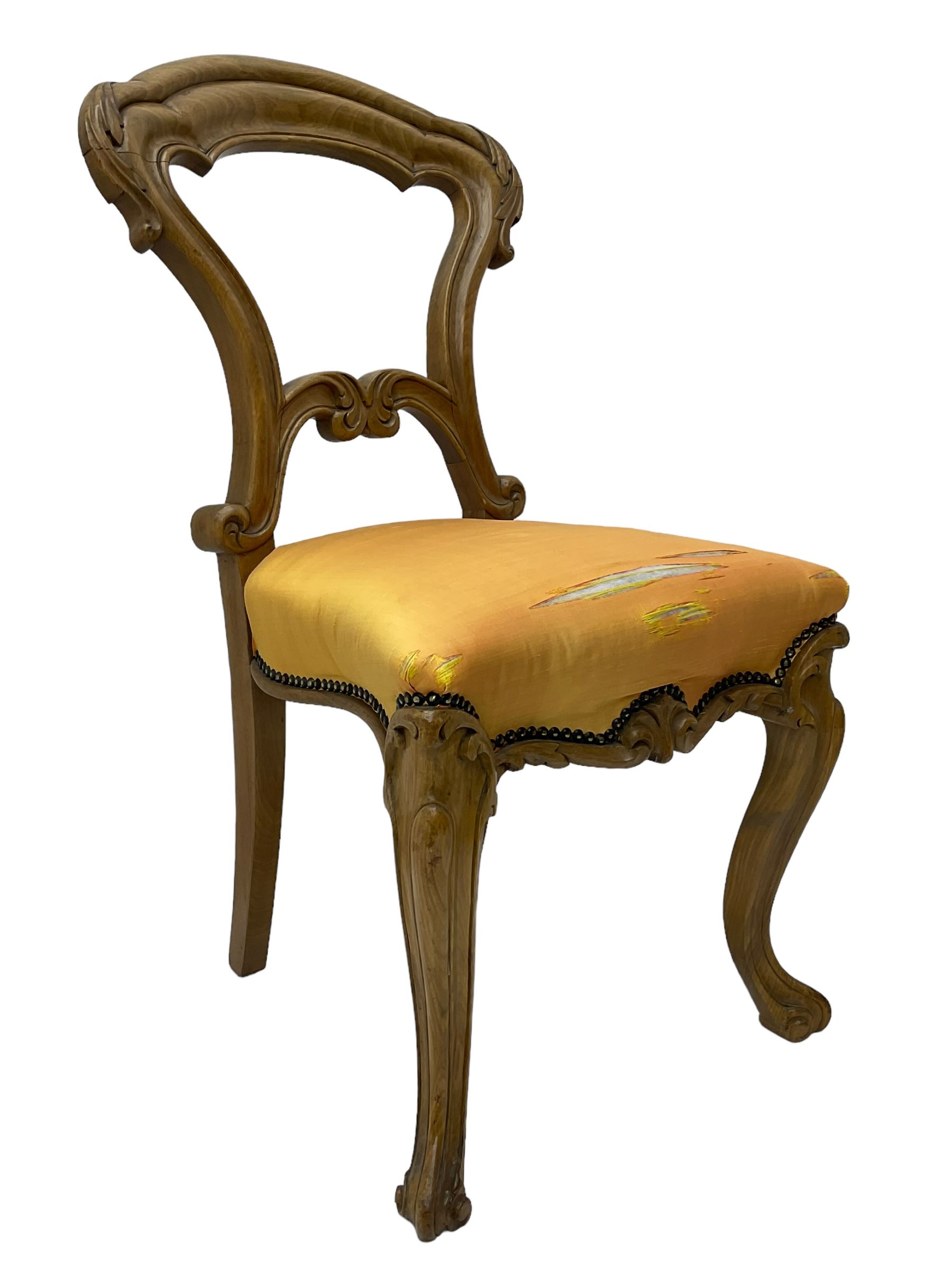 Pair of Victorian walnut side chairs, shaped cresting rail carved with acanthus leaves, overstuffed upholstered seats with stud band, on cabriole supports with scroll carved terminals