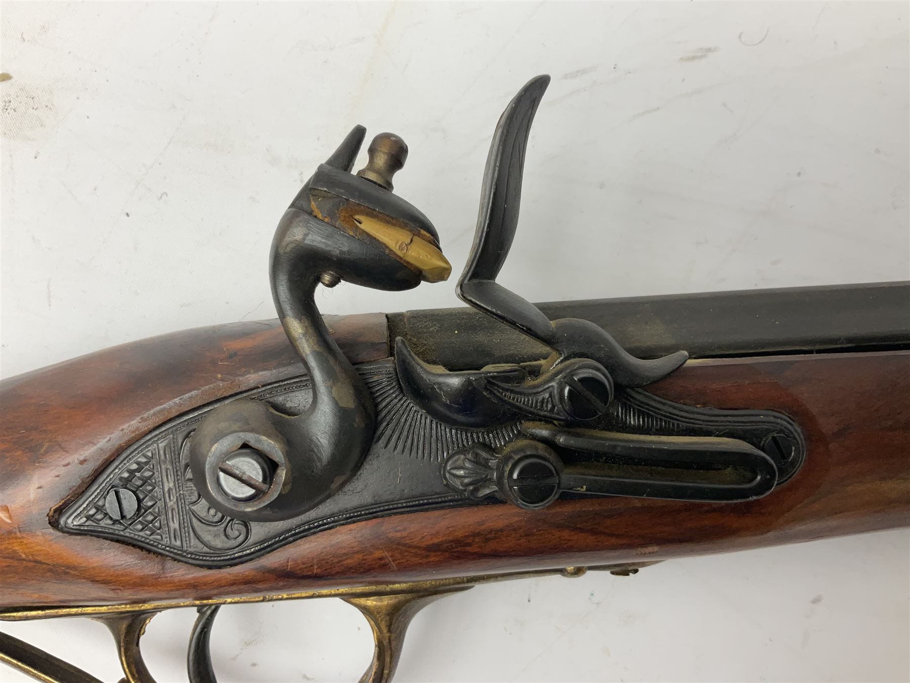 Reproduction non-firing Kentucky style flintlock musket musket, the 87.5cm hexagonal barrel with ramrod under, brass and brassed furniture and patch box to walnut stock L131cm overall