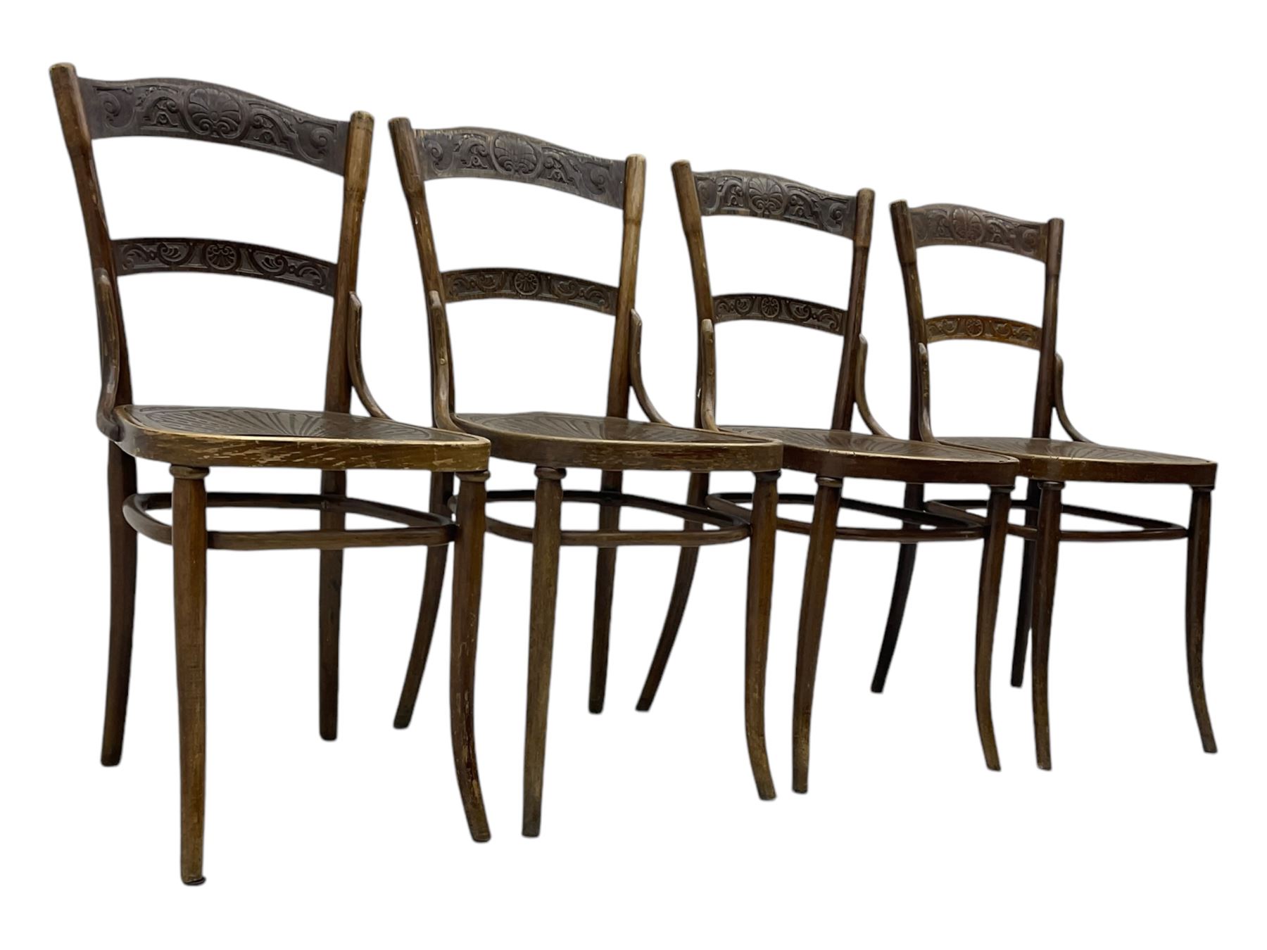 Jacob & Josef Kohn - set of four early 20th century Austrian bentwood chairs, each with carved decoration to the shaped backrest and shaped seat, on splayed supports with stretchers, marked with the manufacturer's stamp and paper label beneath
