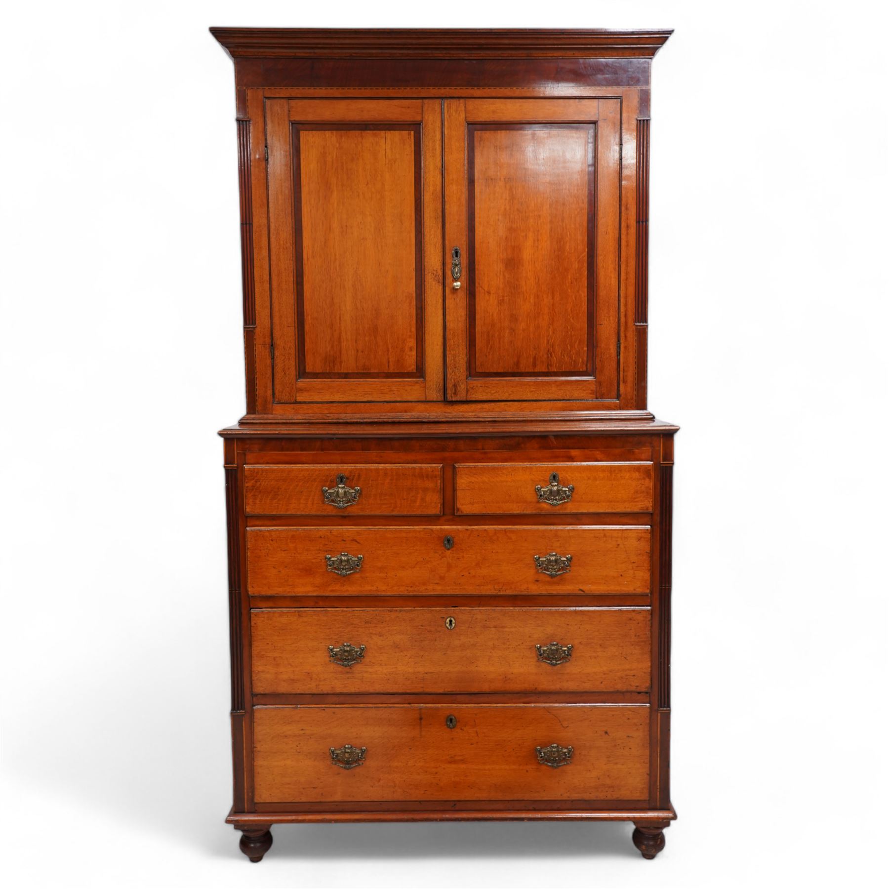 George III oak and mahogany banded house keeper's press cupboard, projecting cornice over figured mahogany frieze with Tunbridge ware pattern bands, two panelled doors enclosing shelves, fitted with two short over three long drawers, flanked by reeded columns throughout, on turned feet