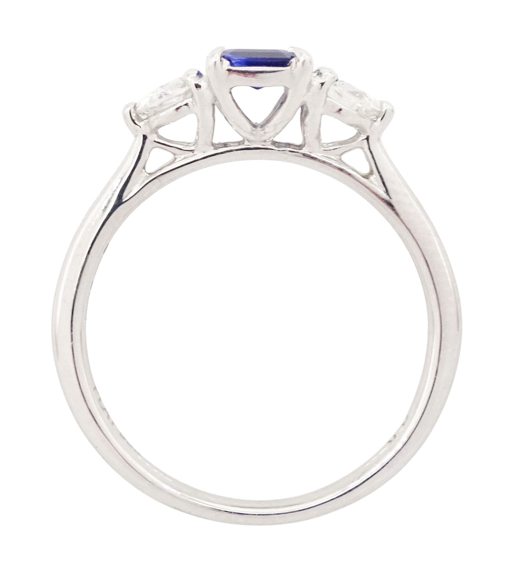 Platinum sapphire and diamond three stone ring, single emerald cut sapphire of approx 0.70 carat, either side set with two round brilliant cut diamonds, hallmarked, total diamond weight approx 0.50 carat