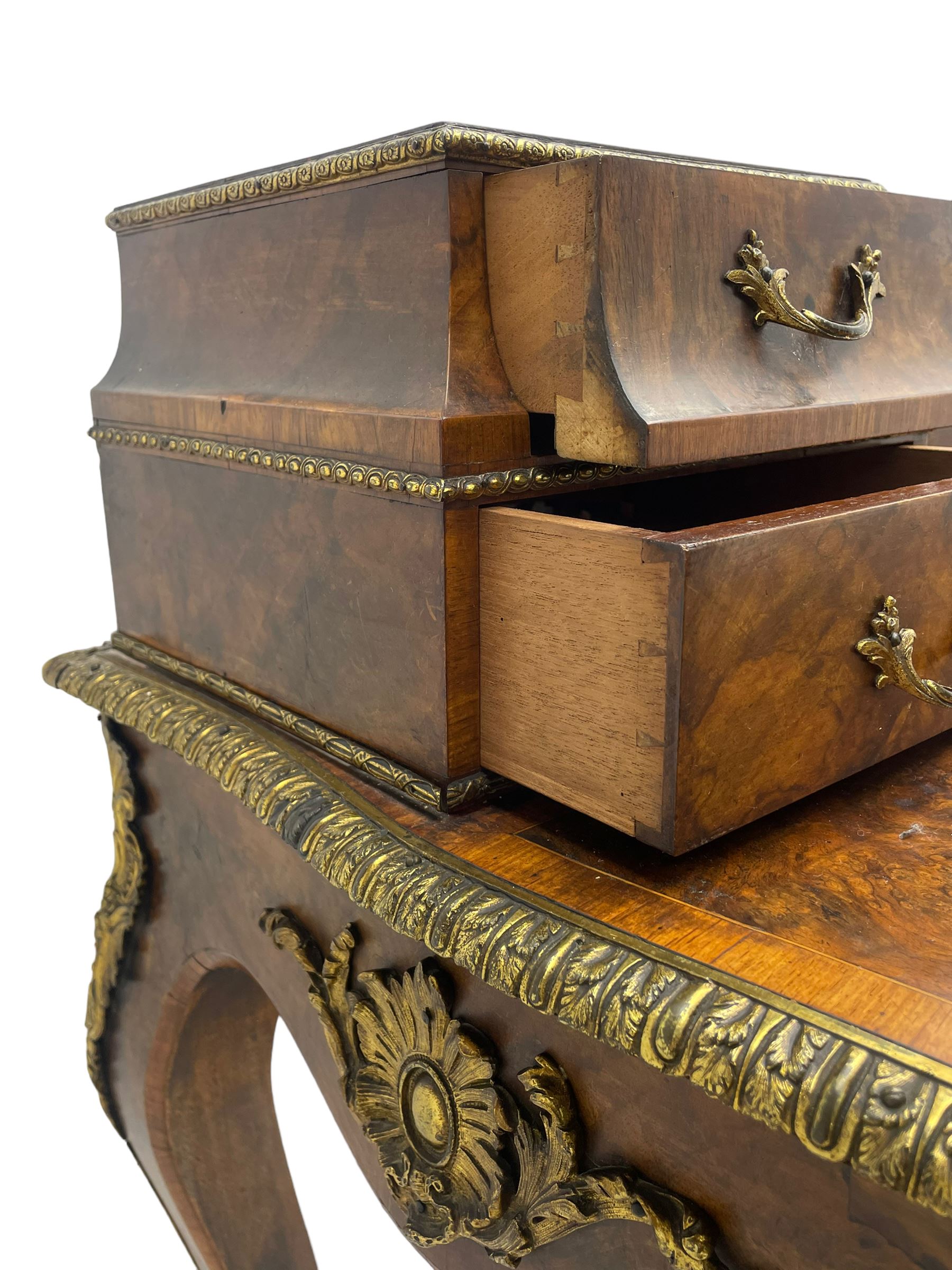 Late 19th to early 20th century French figured walnut writing desk, raised back fitted with drawers, shaped top with Kingwood banding and foliage cast edge moulding, fitted with single drawer, on cabriole supports mounted by shell and flower head cartouches 