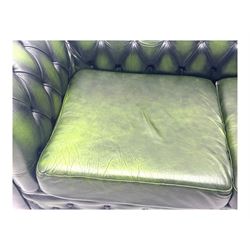 Two seat Chesterfield design sofa bed, upholstered in emerald green leather with deep-buttoned detailing, rolled arms, two loose seat cushions, and pull-out 