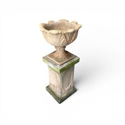Cast stone five sectional urn on plinth, squat leaf and petal design urn on square base