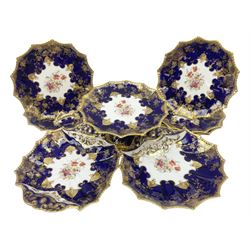 Early 20th century Aynsley dessert service, painted with floral sprays within moulded deep blue and ornate gilt pattern borders, comprising pedestal comport dish, six plates, shell shaped dish and shaped twin handled serving dish, no 4145, all with printed marks beneath