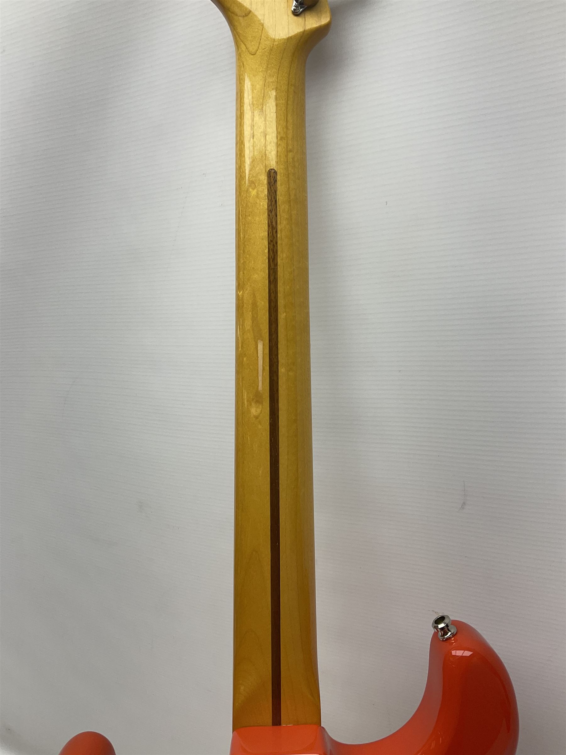 Japanese Squier Fender 'Hank Marvin' Stratocaster electric guitar, c1992, in Fiesta red with tremolo arm and facsimile signature decal; serial no.L037281, L98cm; in hard carrying case.